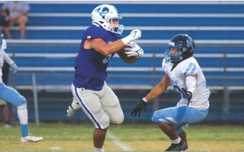Raider Morua makes a defender miss on his way to the end zone last Friday. HUNTER KING | DISPATCH RECORD
