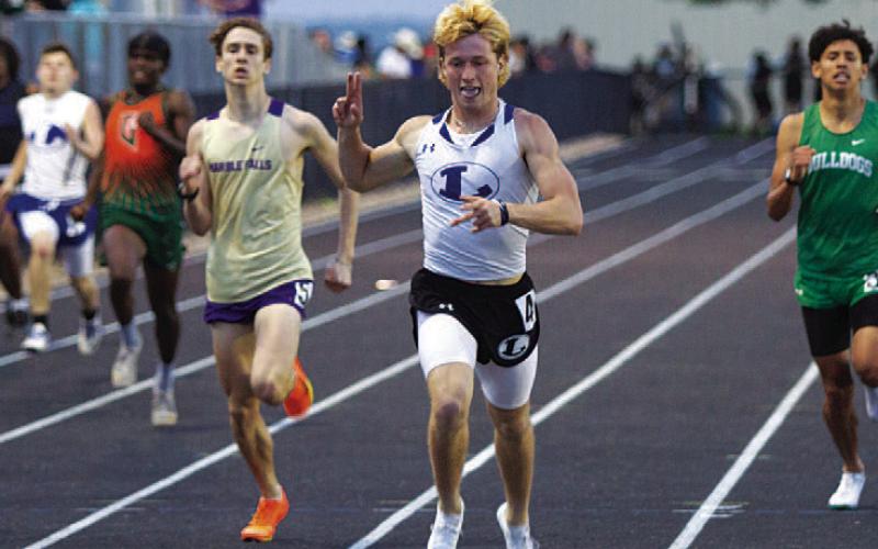 HUNTER KING | DISPATCH RECORD Sean Smith celebrates as he crosses the finish line in the 400-meter dash.