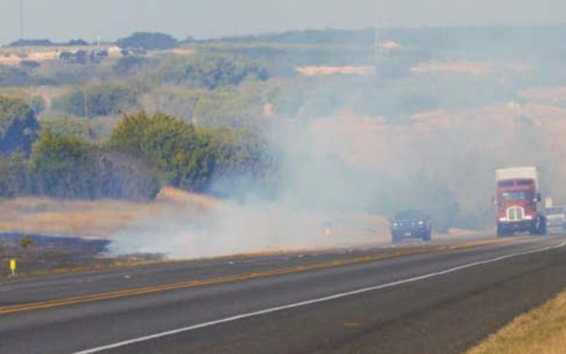 Multiple fire departments and law enforcement agencies responded to a grass fire call Monday afternoon along U.S. Highway 281. MONIQUE BRAND | DISPATCH RECORD