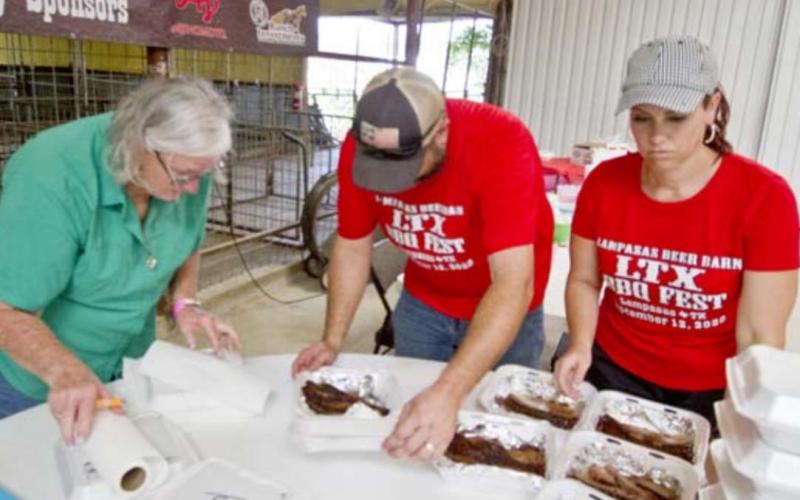 Judy Keeney, at left, Zach Taylor and Brandi Watkins sort trays of brisket for judging at the 2020 LTX BBQ. This year’s festival is an International Barbecue Cookers Association-sanctioned event, and teams can compete in a variety of categories. FILE PHOTO
