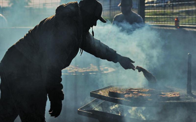 Steaks sizzle on the grill as Lampasas County Livestock Association members prepare for the Buyers Appreciation Dinner. ADAM BARRIOS | DISPATCH RECORD