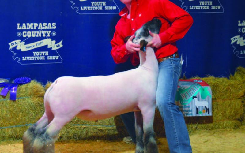 Cayhil Isom claimed grand champion honors with his heavyweight medium wool lamb. ERICK MITCHELL | DISPATCH RECORD