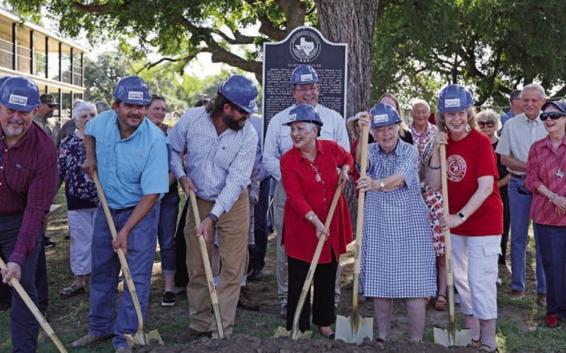 Community members gather to celebrate the upcoming construction work on the Hostess House. Work is set to begin July 1. Pictured in hard hats from left to right are City Council members Davis Keele, Eric Hernandez and Charlie Pratus; Mayor Herb Pearce; Lampasas County Historical Commission representative Clydell Wallce; Carol Northington Wright; and Diane Davis. JOYCESARAH MCCABE | DISPATCH RECORD