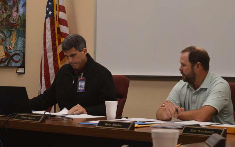 Superintendent Dr. Chane Rascoe, left, and LISD Board of Trustees President Ryan Shahan review updated cost estimates for various facilities that could be added to a bond proposal in the spring. The school board will meet again Tuesday at 6 p.m. to continue talks about potential athletic facility upgrades and a functional capacity for the new Lampasas Middle School that is sought. erick mitchell | dispatch record