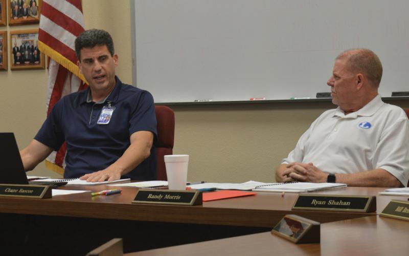 At left, LISD Superintendent Dr. Chane Rascoe discusses education matters with Board of Trustees President Randy Morris during Monday’s meeting. erick mitchell | dispatch record