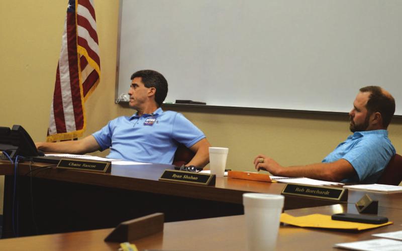 ERICK MITCHELL | DISPATCH RECORD Lampasas ISD Superintendent Dr. Chane Rascoe, at left, and Board of Trustees President Ryan Shahan listen to a presentation on facility needs and the financing options that could be available to address those.
