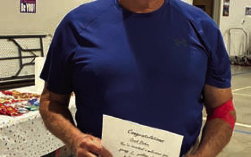Cecil Duhon shows his certificate for having given 2 gallons of blood. COURTESY PHOTO