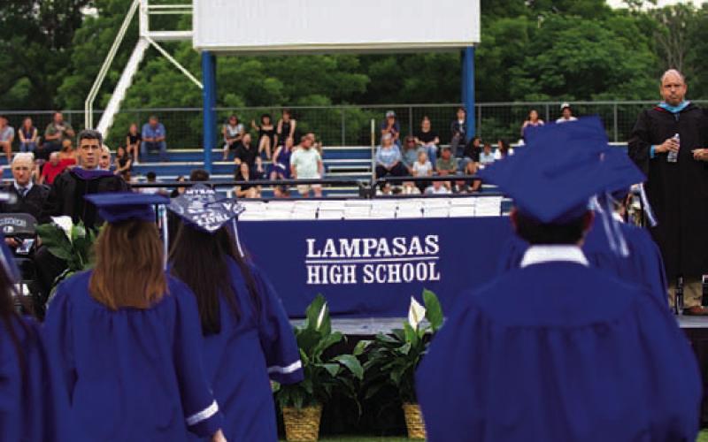 Students walk toward the stage during graduation. HUNTER KING | DISPATCH RECORD