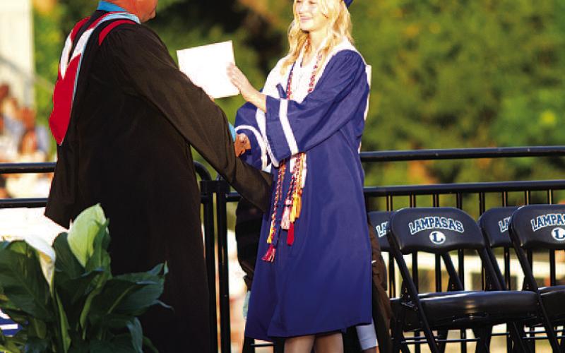 HUNTER KING | DISPATCH RECORD Sagen Plouff takes her diploma from Principal Paul Weinheimer.