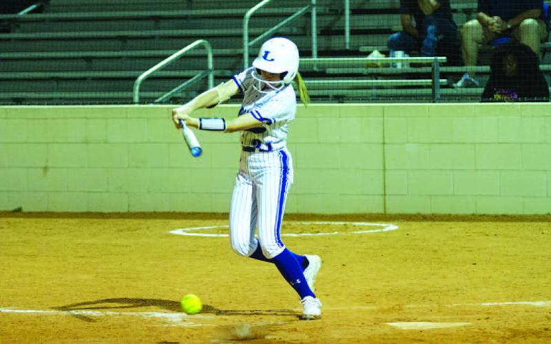 Saegan Plouff slaps a ball into the ground to use her speed to reach base. HUNTER KING | DISPATCH RECORD