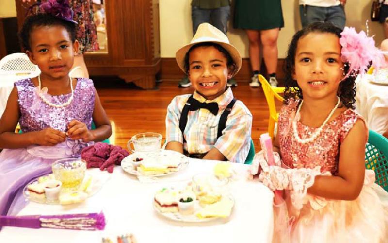 The Davises (from left to right) Silver, age 5, Ra’Nour, age 7, and Orchid, age 4, are dressed in their finest attire from gloves to hats to polished shoes. The siblings enjoyed “tea,” an assortment of finger sandwiches and cookies at this year’s Teddy Bear Tea. JOYCESARAH MCCABE | DISPATCH RECORD