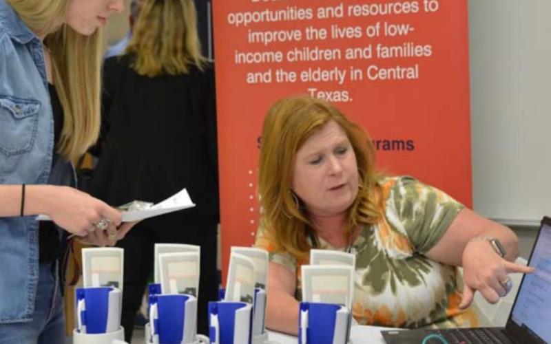 Marlee Hyatt, left, goes over employment information with Hill Country Community Action HR Specialist Regina Baker at last year’s Lampasas Economic Development Corp. job fair. FILE PHOTO