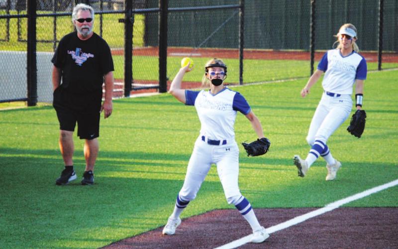 Hadley Oncken reaches back to throw to first after catching a pop-up at third base in last Friday’s contest. HUNTER KING | DISPATCH RECORD
