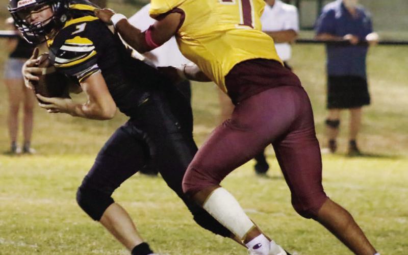 Leonel Caso wrangles a Jonesboro runner during Friday’s contest. MASON HINES | DISPATCH RECORD