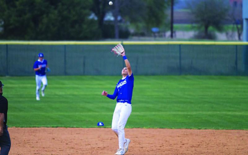 Kade Landry watches a pop-up fall into his glove during the district-opening victory. HUNTER KING | DISPATCH RECORD