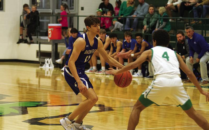 Luke Shivers dribbles at the top of the key during the first half of the Burnet game. HUNTER KING | DISPATCH RECORD