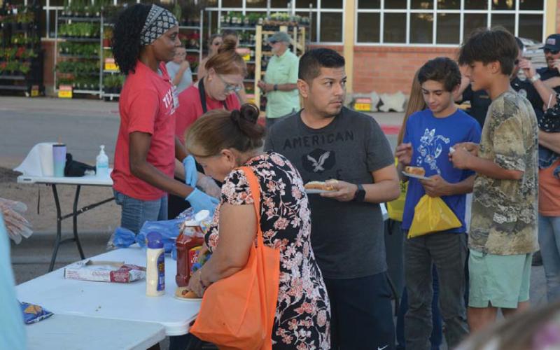 The Lampasas H-E-B provided 600 hot dogs and buns for Tuesday’s Natonal Night Out, making it a popular stop for attendees. Erick Mitchell | dispatch record