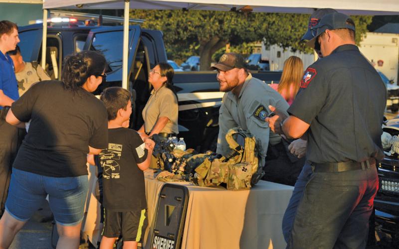 Children enjoyed stopping by the Lampasas County Sheriff’s Office table showcasing new equipment and the department’s Special Response Team. Erick Mitchell | dispatch record