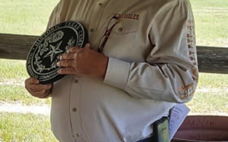 COURTESY PHOTO Rock Church Cemetery Association President Cory Craft holds the historical medallion during a recent dedication ceremony.