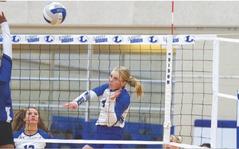 Brylie Turner swings through the ball during last Friday’s match. HUNTER KING | DISPATCH RECORD
