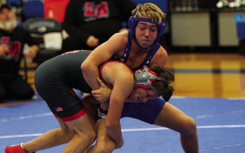 HUNTER KING | DISPATCH RECORD Laeton Kepler grapples with his opponent during the wrestling meet Wednesday night.