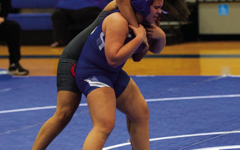 HUNTER KING | DISPATCH RECORD Taylor Blocker attempts to get her opponent off her back during the meet.