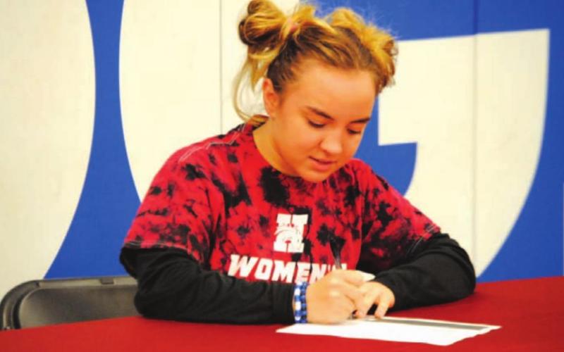 Brianna Miller signs her letter of intent to wrestle for Hastings College in Nebraska. HUNTER KING | DISPATCH RECORD
