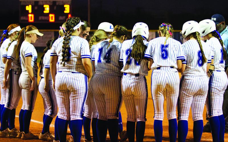 Members of the softball team surround home plate to celebrate a Madison Magilke home run against Marble Falls. HUNTER KING | DISPATCH RECORD