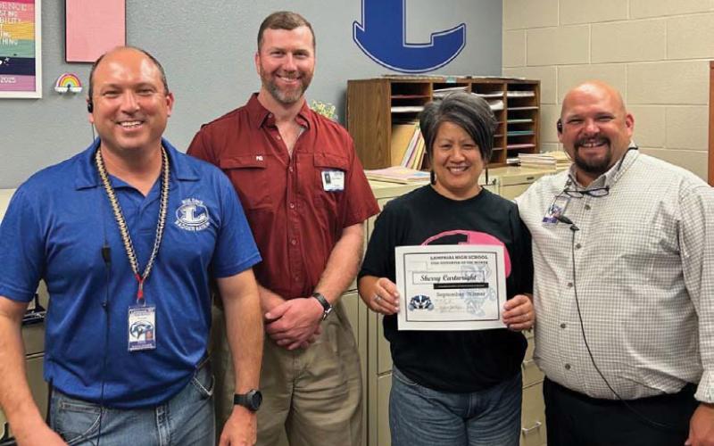 courtesy photo Lampasas High School has named Sherry Cartwright the campus Support Staff of the Month. Assistant Principal Ryan Race, at right, said she “is a joy and a ray of sunshine. She makes everyone’s day better when they speak with her.” Also pictured: Principal Paul Weinheimer, at left, and Texas Farm Bureau Insurance representative Clay Phillips.