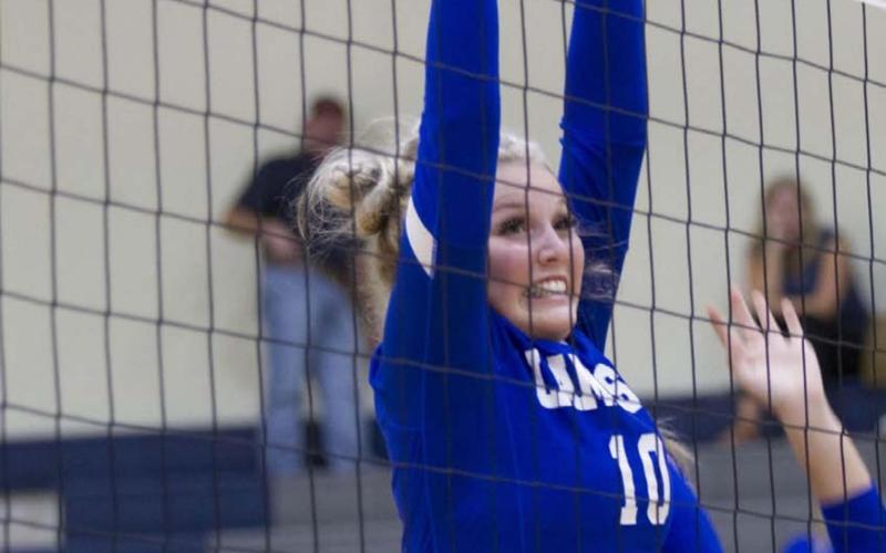 Laurcy Bender reaches up for a block during the Lady Badgers’ match against the Jarrell Lady Cougars. Lampasas is set to play Burnet on the road Friday. HUNTER KING | DISPATCH RECORD