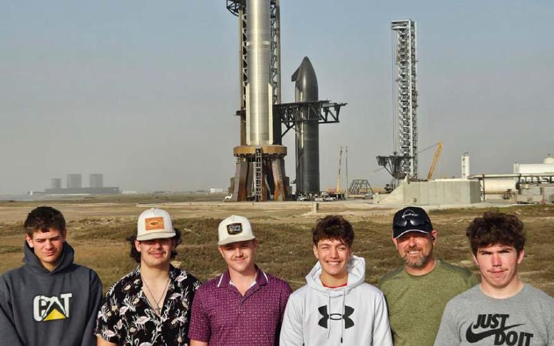 Lometa High School’s drone class got up close and personal with SpaceX’s eighth Starship flight test rocket. The group was able to view the rocket from a few hundred yards away. Pictured left to right are Stone Carr-Jones, Lukas Smailus-Cruz, Colten Whitehead, Ivan Oliver, Superintendent Rob Moore and Roy Carr. COURTESY PHOTO