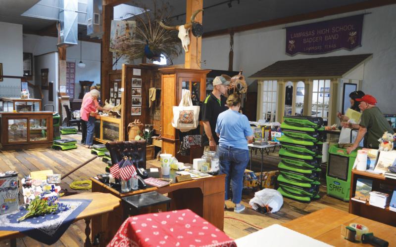 erick mitchell | dispatch record Museum volunteers are shown working to clear the gift shop area, which sustained damage May 10 when rain came through a leaky roof. Serve Pro representatives were on hand with their equipment to remove the water and excess moisture from the main floor of the building.