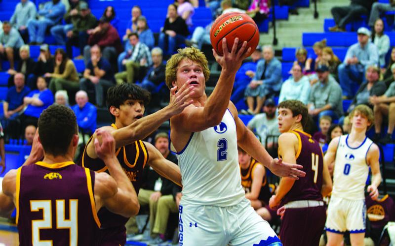 Haegan Oncken cuts through Thorndale defenders for a layup during the first half of Tuesday’s game. HUNTER KING | DISPATCH RECORD