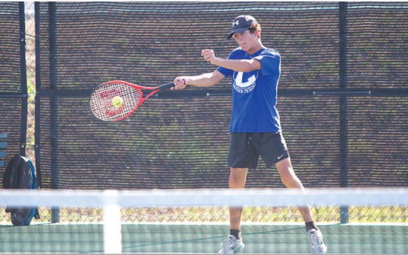 Brock Messinger swings through a forehand shot during Tuesday’s win over Glen Rose. The Badgers took every match. HUNTER KING | DISPATCH RECORD