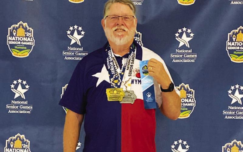 COURTESY PHOTO | WYMAN POWERS Powers poses with his gold and silver medals as well as a ribbon he earned for bowling.
