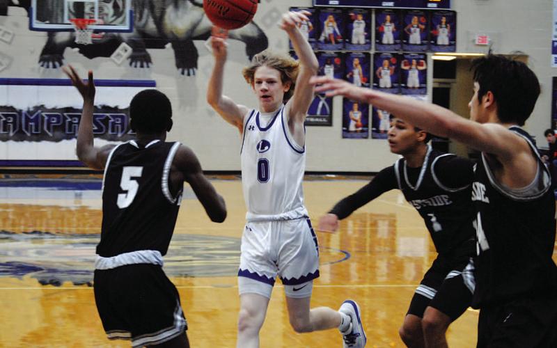Peyton Sisson makes a pass to a teammate for one of his seven assists in Tuesday’s game. HUNTER KING | DISPATCH RECORD