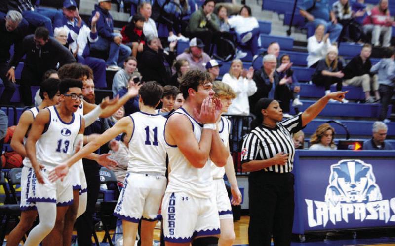 The Badgers celebrate their first win of the season after the final buzzer sounded. HUNTER KING | DISPATCH RECORD