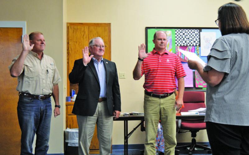 Lampasas Independent School District trustees elected in May take their oath of office on Monday. Trustees Randy Morris, at left, and Rob Borchardt, third from left, were re-elected without opposition to new three-year terms. Mickey Edwards, in center, was the voters’ choice to take the seat being vacated by retiring member Bill Brister. ERICK MITCHELL | DISPATCH REACORD