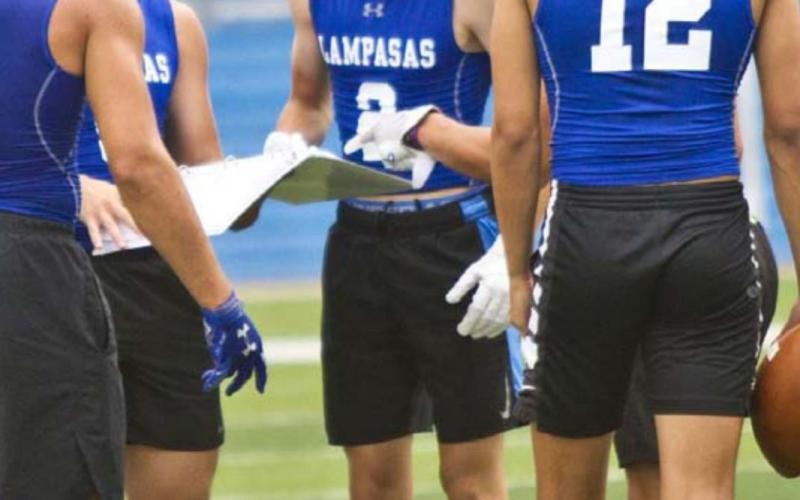 Badger players, left to right, Aden Rascoe, Dax Brookreson, Owen Stubbs, Ethan Moreno and Dylan Sanchez look at plays in the huddle at a 7-on-7 game last week in Georgetown. JEFF LOWE | DISPATCH RECORD e, Dax Brookreson,