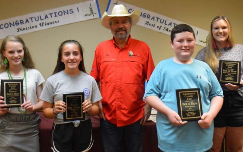 The 2021 County Fair Best of Show winners included Allison Martin and Payton Crawford, at left; and Grant Gill and Megan Caddies, at right. They are pictured with fair sponsor Lee Hoffpauir. MONIQUE BRAND | DISPATCH RECORD