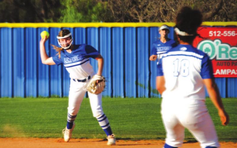 Kamryn Kothmann sets to throw to Alycia Cantu at first during the game last Thursday. HUNTER KING | DISPATCH RECORD
