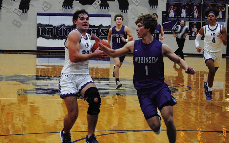 Carter Johnson drives past a defender for a layup in the Badgers’ home game. HUNTER KING | DISPATCH RECORD