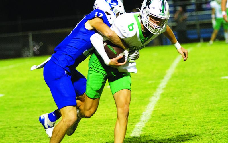 HUNTER KING | DISPATCH RECORD Sean Smith makes a tackle while ripping the football out to force a fumble.