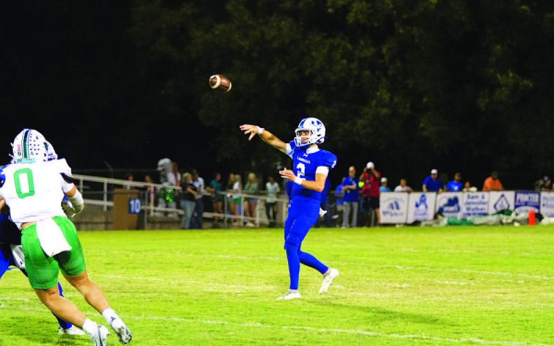 Bryson Roberts tosses a pass over the middle during the game against Burnet. HUNTER KING | DISPATCH RECORD