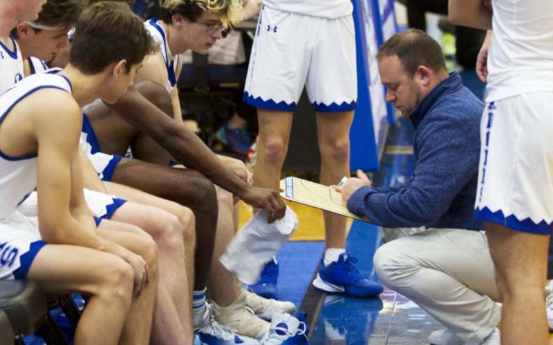 Lampasas head coach Aaron Nuckles is shown in this photo from a previous game drawing up a play for the Badgers. Although outside shooting was poor at Stephenville, the team was able to power past the Yellowjackets in the overtime period to solidify the first district win of 2022. FILE PHOTO
