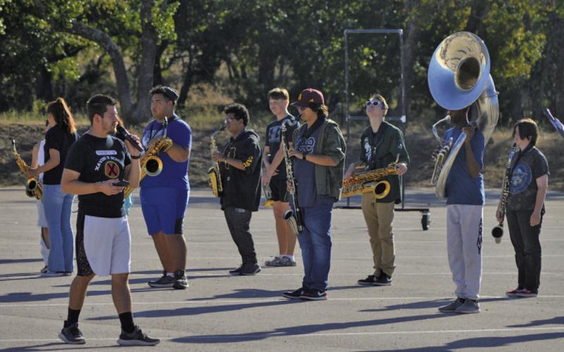 Lampasas High School band director Eduardo Zambrano leads the Badger Band through marching practice earlier this fall. Nineteen LHS band students earned All-Region honors. ERICK MITCHELL | DISPATCH RECORD