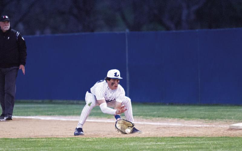 Drew Davis fields a ground ball at first base against the Bulldogs. HUNTER KING | DISPATCH RECORD