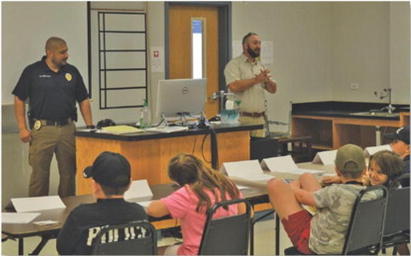 Students listen to officers from the Lampasas Police Department during Tuesday’s Jr. Police Academy session at the Lampasas County Higher Education Center. ERICK MITCHELL | DISPATCH RECORD