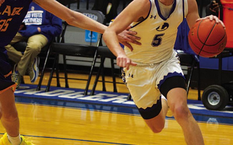 Trent Seneca drives the baseline during last Friday’s game against the Vikings. HUNTER KING | DISPATCH RECORD