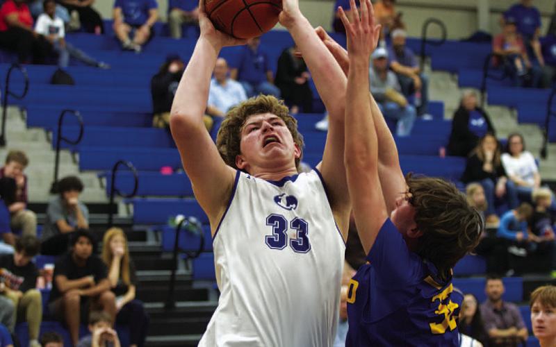 Beau Patterson goes up through contact for two of his 12 points against Lago Vista. HUNTER KING | DISPATCH RECORD